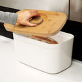 Bread Bin with Bamboo Lid Keep all your bread, rolls and pastries fresher for longer in this stylish bread bin, with a specially designed bamboo lid that doubles as a cutting board for chopping up your bread. Easy-clean storage bin with non-slip base Reve