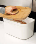 Bread Bin with Bamboo Lid Keep all your bread, rolls and pastries fresher for longer in this stylish bread bin, with a specially designed bamboo lid that doubles as a cutting board for chopping up your bread. Easy-clean storage bin with non-slip base Reve
