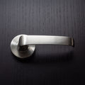 Noosa Lever Handle. Features: Solid stainless steel handleStainless steel rose cover and diecast baseConcealed through-bolt rose fixing Press fit rose cover Finish: Satin stainless steel Door thickness: Passage 32 - 50Privacy 32 - 42 Spindle: Ø7.6 Centre:
