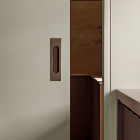Flush solid brass cavity pull in bronze finish, recessed cabinet and drawer handle