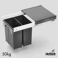 Hettich Atira Bin Set – Includes Drawer – White The Hettich Atira Bin Set in White offers a sleek, space-saving waste management solution for modern kitchens. This complete unit includes a high-quality Atira steel drawer in a crisp white finish, integrate