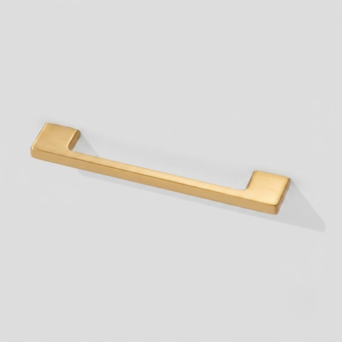 A modern horizontal cabinet pull handle with a brushed gold finish, shown on a light gray background.