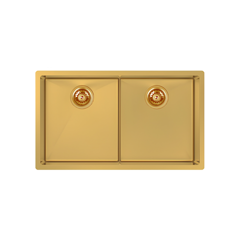 A rectangular double-sink kitchen faucet basin in a polished gold finish, featuring two circular drain openings on the front, shown against a solid white background.