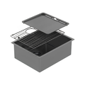 A dark gray drop-in farmhouse sink with a two-basin layout, shown with its matching dark gray drain cover and wire drying rack lifted above the basin, set against a plain white background.