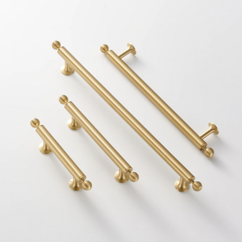Renzo solid brass handle in satin brass finish, modern minimalist cabinet and door pull with smooth texture and durable construction for kitchen or bathroom interiors.