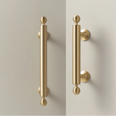 Renzo solid brass handle in satin brass finish, modern minimalist cabinet and door pull with smooth texture and durable construction for kitchen or bathroom interiors.