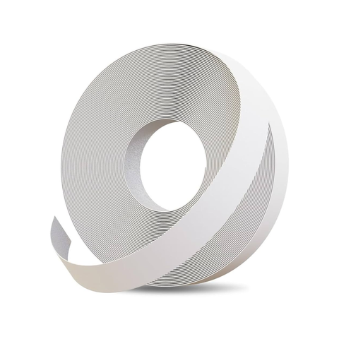 A roll of white adhesive tape, partially unrolled to show its textured, ribbed backing, set against a plain white background with a soft shadow underneath.