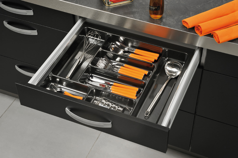 Häfele Excel utensil tray fitted in an open kitchen drawer, its wide compartments holding a whisk, ladle, grater and cutlery