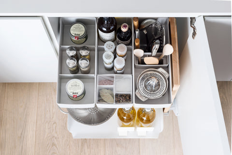 Top view of Peka Kitchen Tower caddy with compartments of spice jars, utensils and a citrus juicer