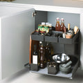 Peka Kitchen Tower anthracite pull-out caddy in a kitchen base cabinet, holding oils, spices, bottles and a mixing bowl