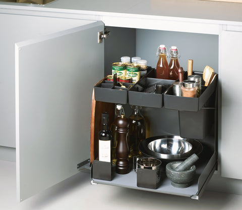 Peka Kitchen Tower anthracite pull-out caddy in a kitchen base cabinet, holding oils, spices, bottles and a mixing bowl