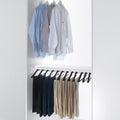 Peka Lina anthracite pull-out trouser rack in a white wardrobe, holding trousers on individual hangers below a shelf of shirts