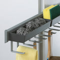 Close-up of Peka Pesolo anthracite pull-out tray and hooks holding sponges and a cleaning cloth
