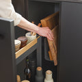 Close-up of Peka Pinello Board anthracite pull-out with a wooden chopping board being lifted from the integrated rack