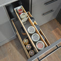 Top view of Peka Pinello Cargo anthracite kitchen base unit pull-out organising spice and condiment jars on bamboo-trimmed tiered shelves