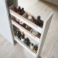 Peka Pinello Spice white base unit pull-out viewed from above, holding oil bottles and spice jars across tiered shelves