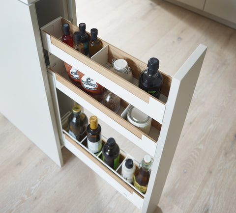 Peka Pinello Spice white base unit pull-out viewed from above, holding oil bottles and spice jars across tiered shelves