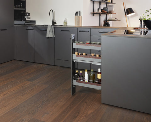 Peka Pinello Spice anthracite narrow pull-out extended from a dark kitchen cabinet, organising oil bottles and jars