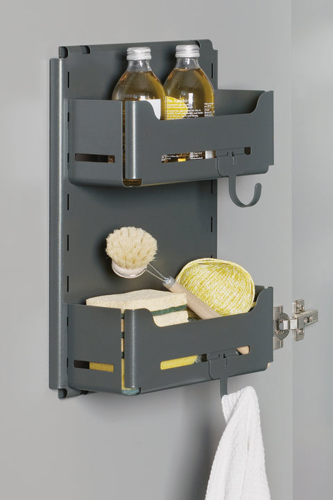 Peka Sesam Mini anthracite wall-mounted adjustable shelves holding cleaning bottles, a dish brush and sponges