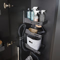 Peka Sesam Standard anthracite cleaning cupboard shelving system holding spray bottles, cloths, a vacuum hose and a basket