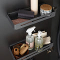 Peka Tablo Libell anthracite hang-on storage trays mounted inside a cupboard door, holding cleaning bottles, brushes and sponges