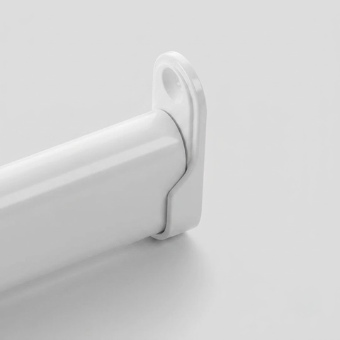 A close-up of a white curtain rod finial and wall mount bracket on a light gray background.